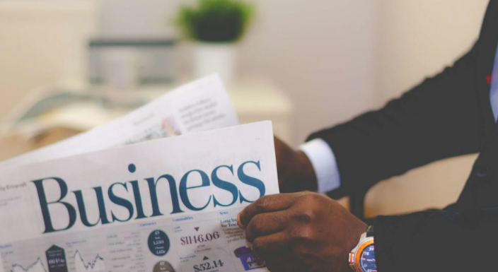 Person Holding White and Blue Business Pape