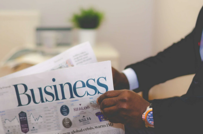 Person Holding White and Blue Business Pape